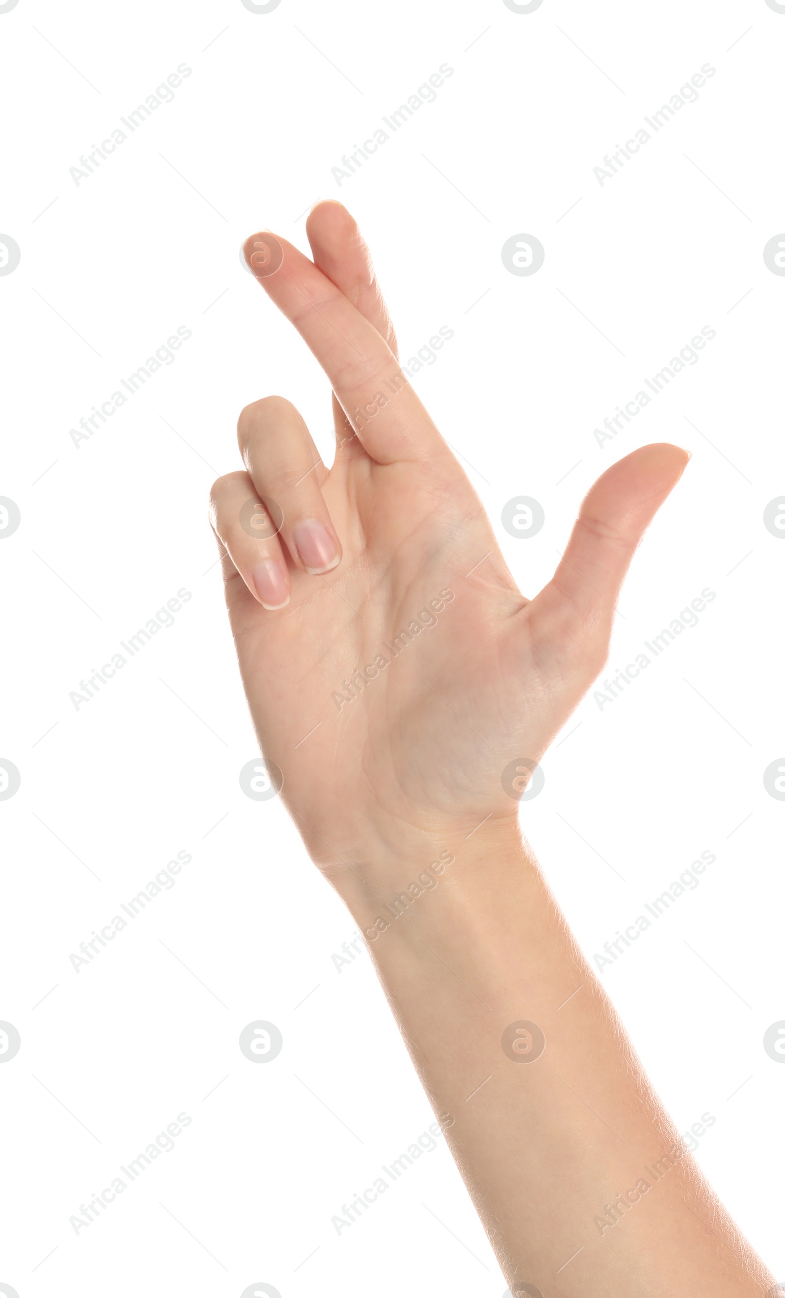 Photo of Woman with crossed fingers on white background, closeup. Superstition concept