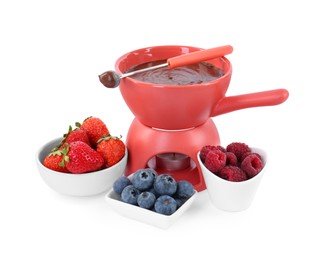 Photo of Fondue pot with melted chocolate, fresh berries and fork isolated on white