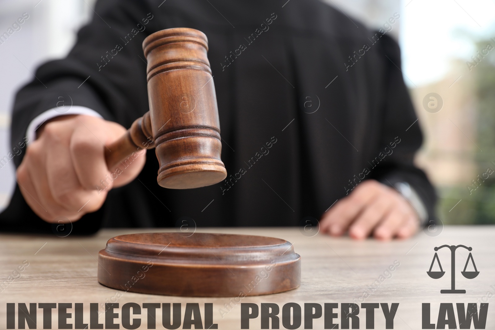 Image of Intellectual property law. Judge with gavel at table, closeup