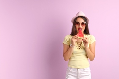 Photo of Beautiful young woman posing with watermelon on color background