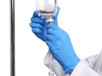 Nurse setting up IV drip on white background, closeup