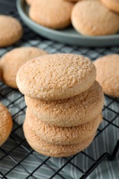 Photo of Delicious sugar cookies on cooling rack, closeup