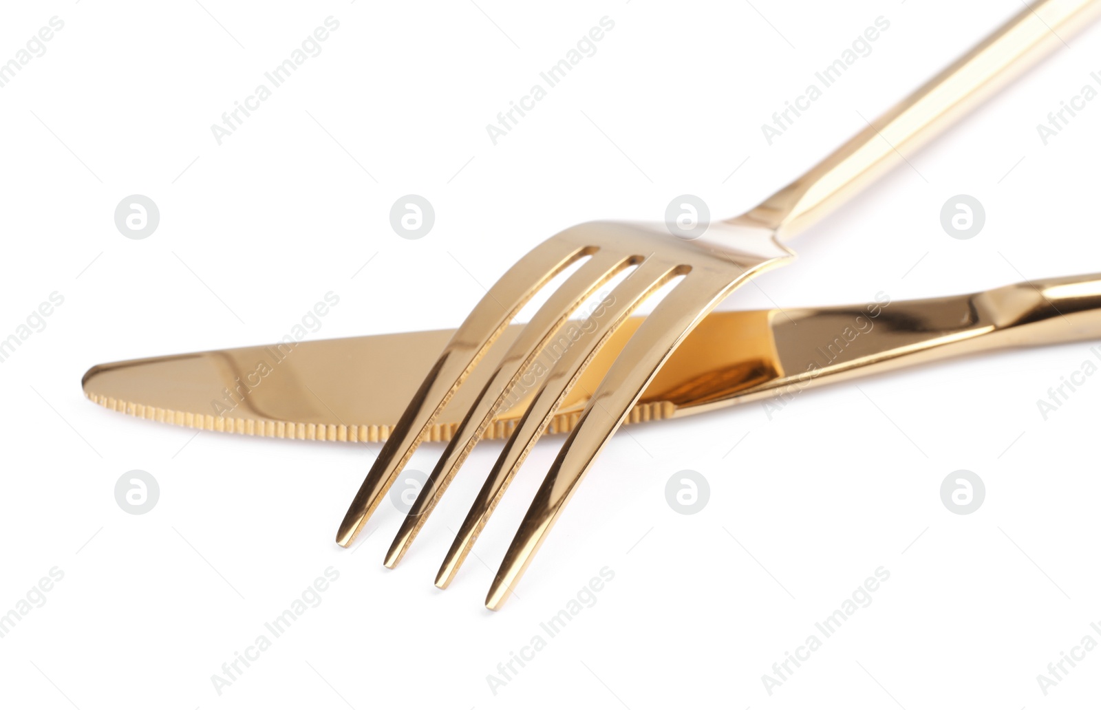 Photo of Golden fork and knife on white background