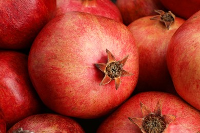 Photo of Many fresh ripe pomegranates as background, closeup