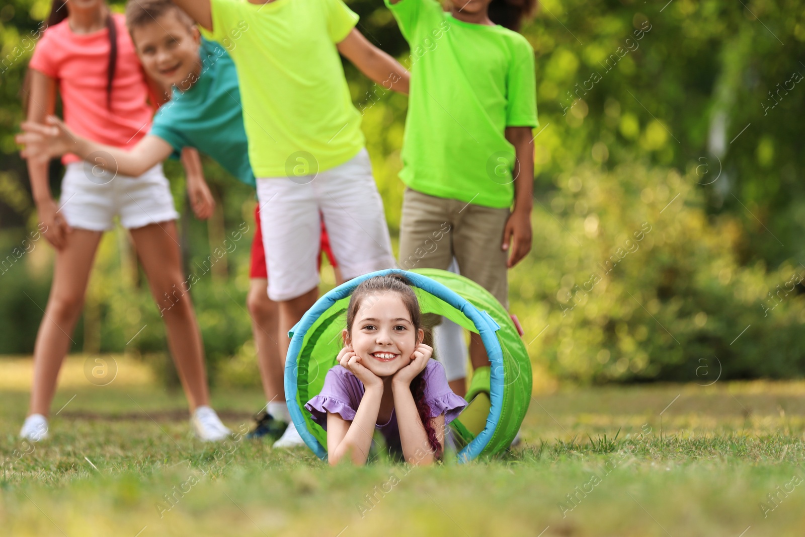 Photo of Cute little child playing with friends in park