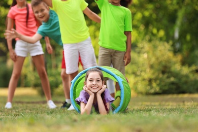 Photo of Cute little child playing with friends in park