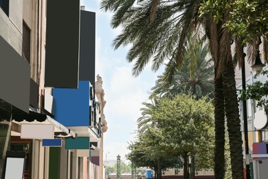 Photo of Beautiful view of city street with modern buildings and palm trees