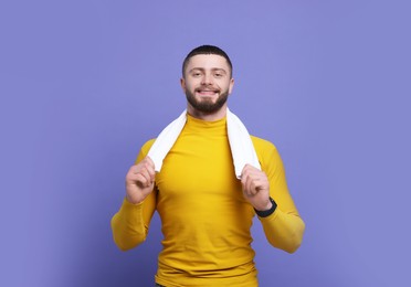 Photo of Handsome man with white towel on purple background
