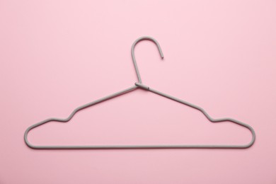 Photo of One hanger on pink background, top view