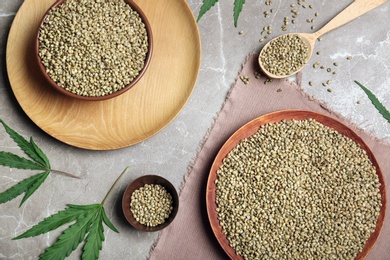 Flat lay composition with hemp seeds on grey background