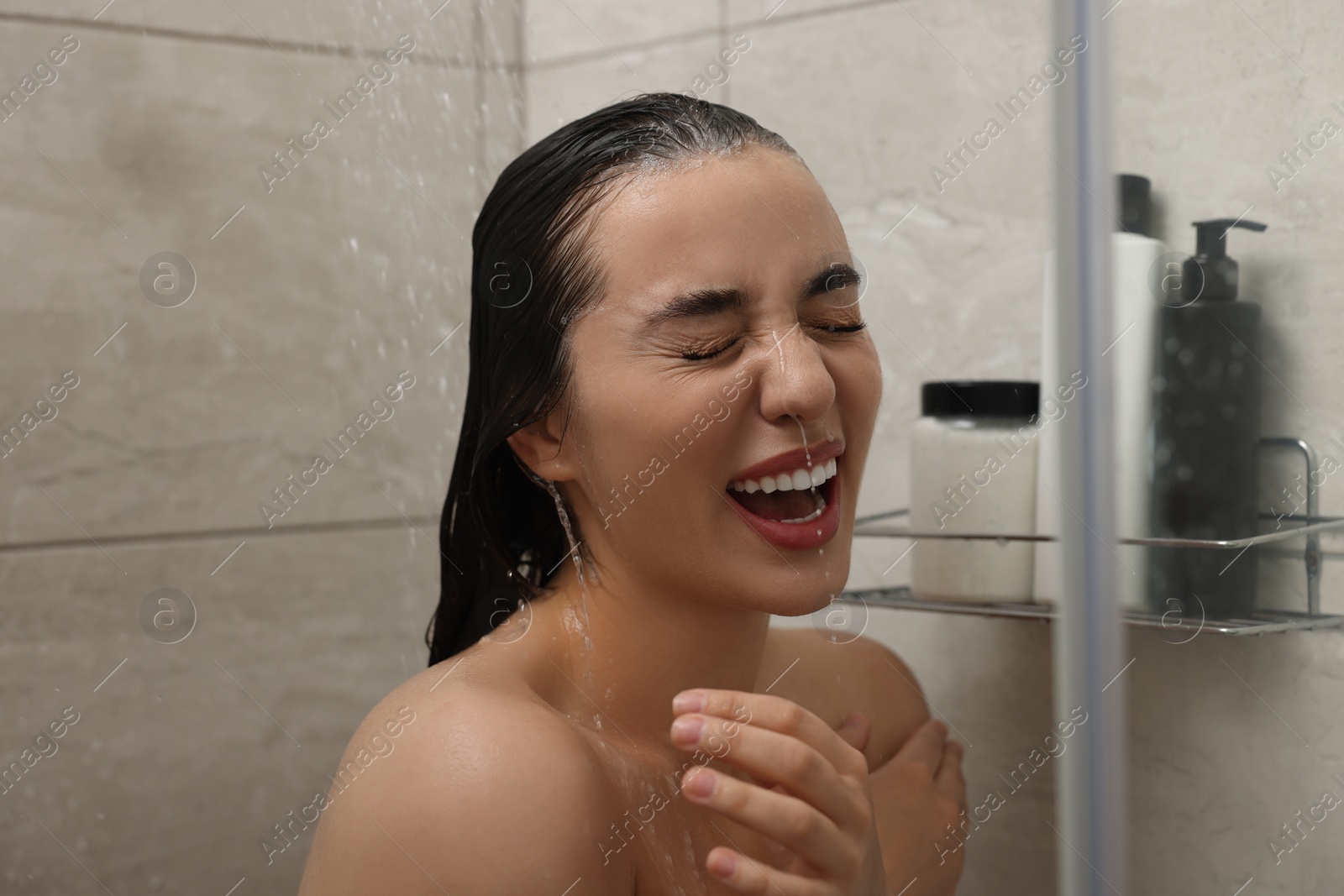 Photo of Washing hair. Happy woman in shower stall