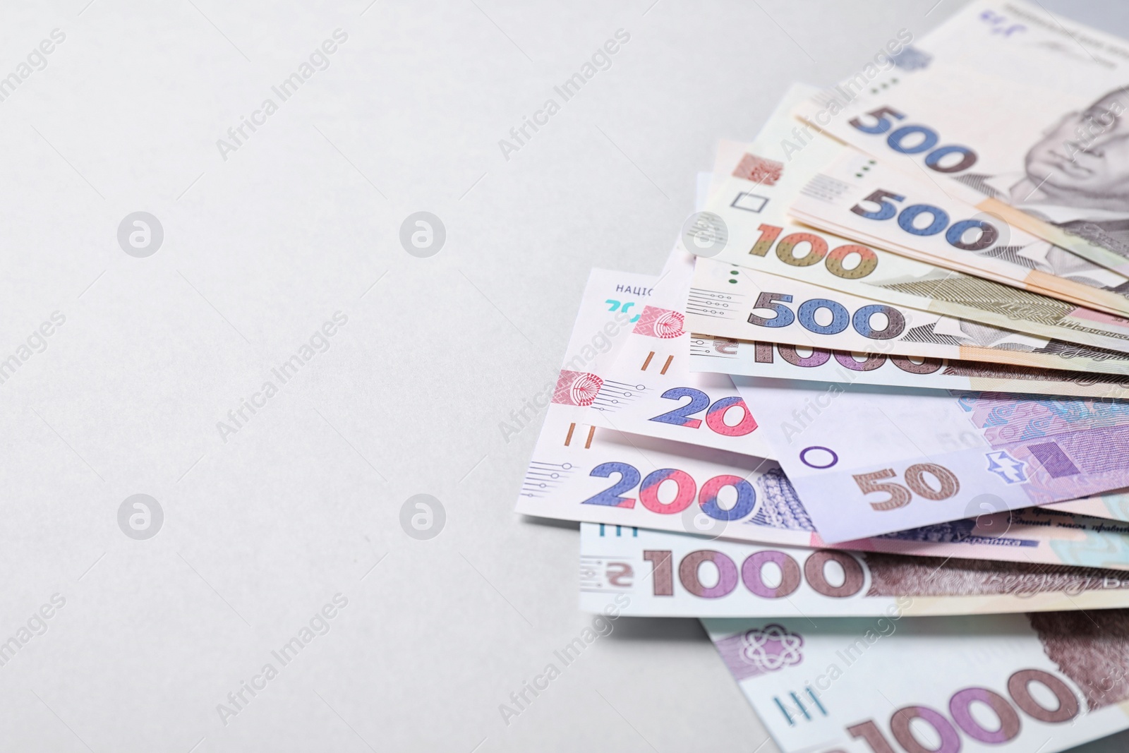 Photo of Ukrainian money on white background, closeup. Space for text
