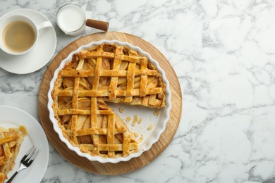 Photo of Tasty homemade quince pie served on white marble table, flat lay. Space for text