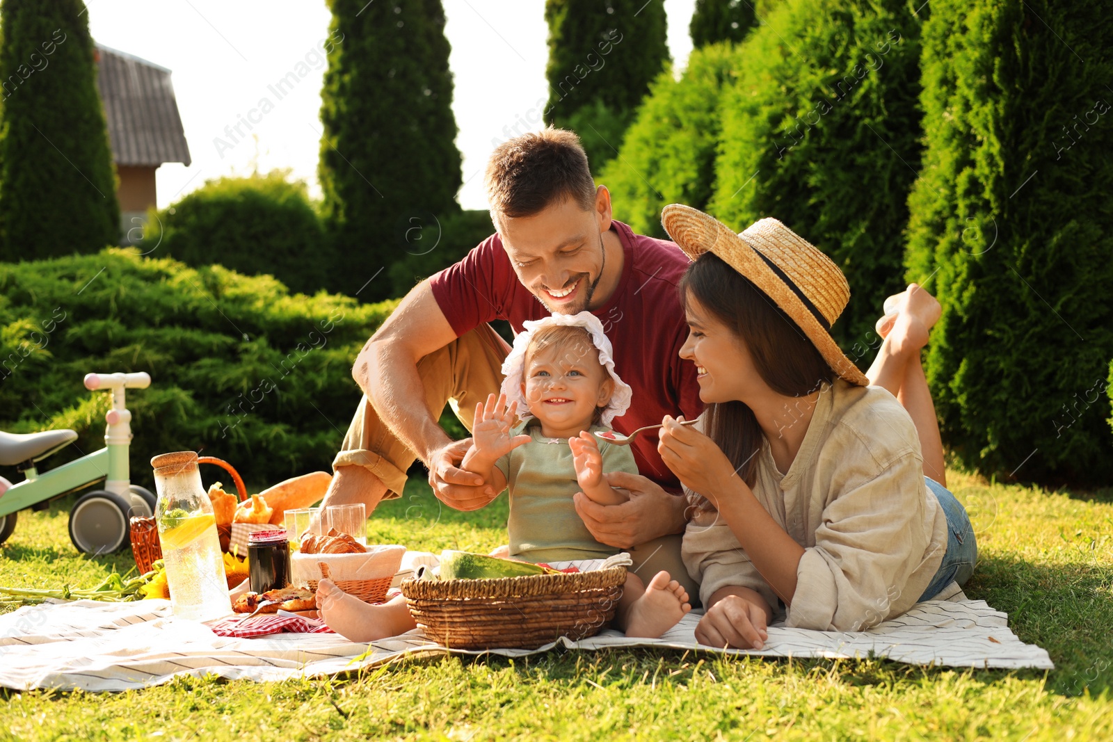 Photo of Happy family having picnic in garden on sunny day