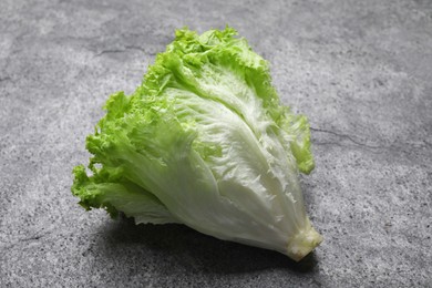 Photo of Fresh lettuce on stone table. Salad greens