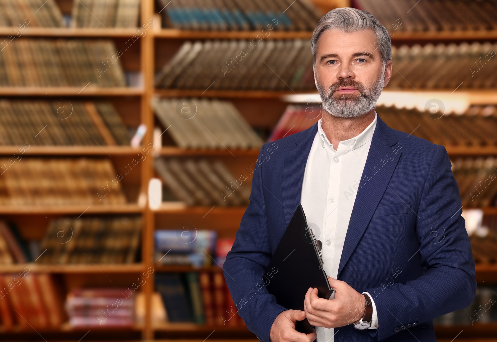 Image of Lawyer with clipboard against shelves with books, space for text