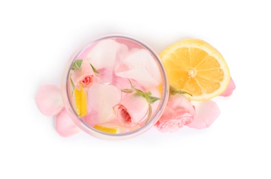 Photo of Tasty refreshing lemon drink with roses on white background, top view