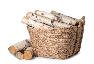 Photo of Wicker basket with cut firewood isolated on white