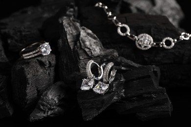 Stylish presentation of elegant jewelry on coal