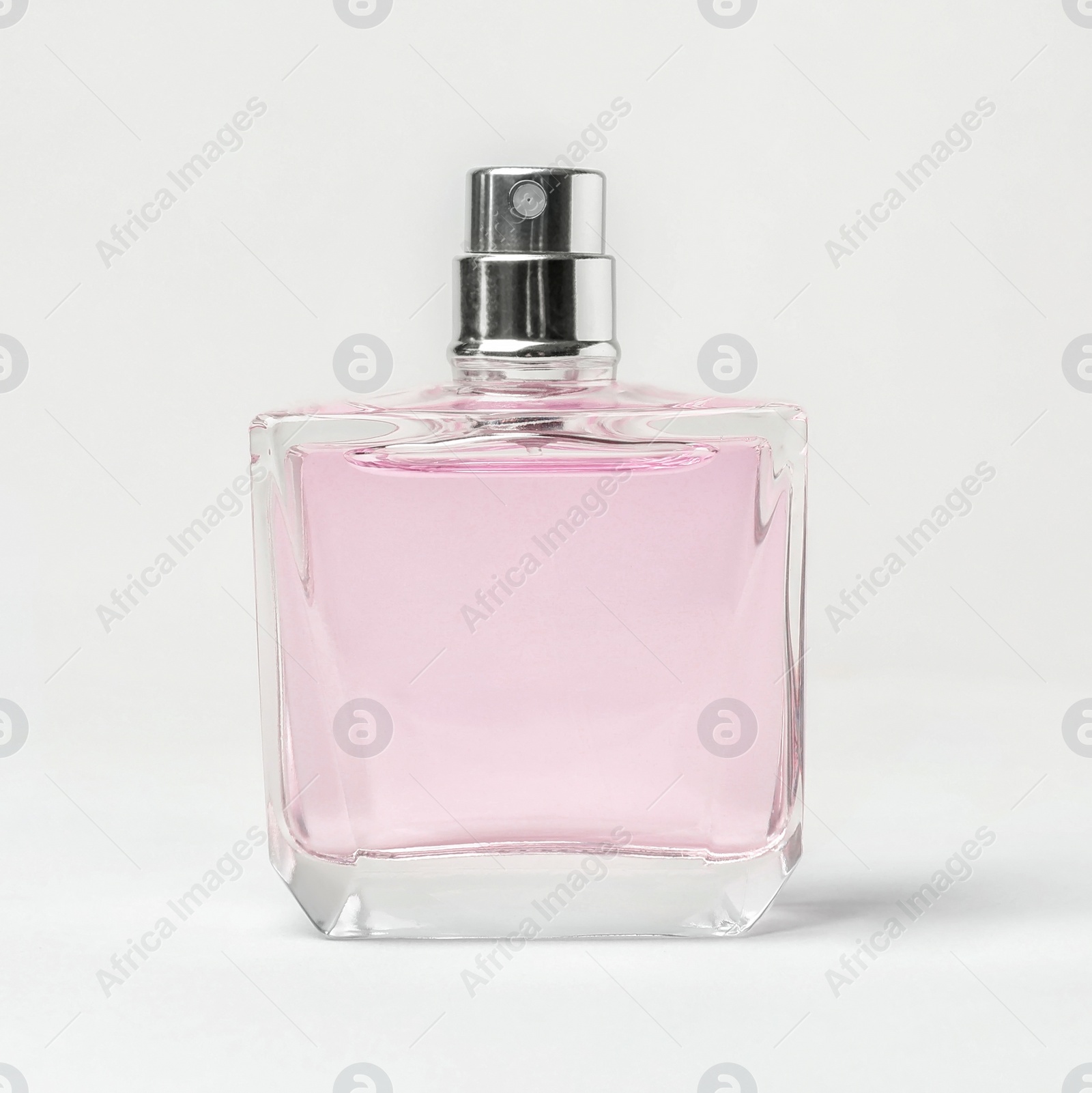 Photo of Transparent bottle of perfume on white background