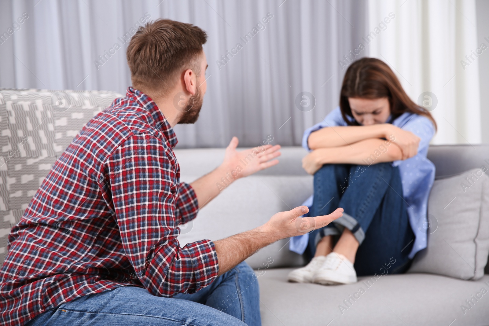 Photo of Couple having quarrel at home. Relationship problems