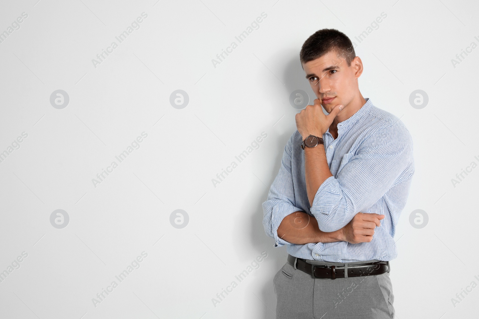 Photo of Portrait of handsome young man on light background. Space for text