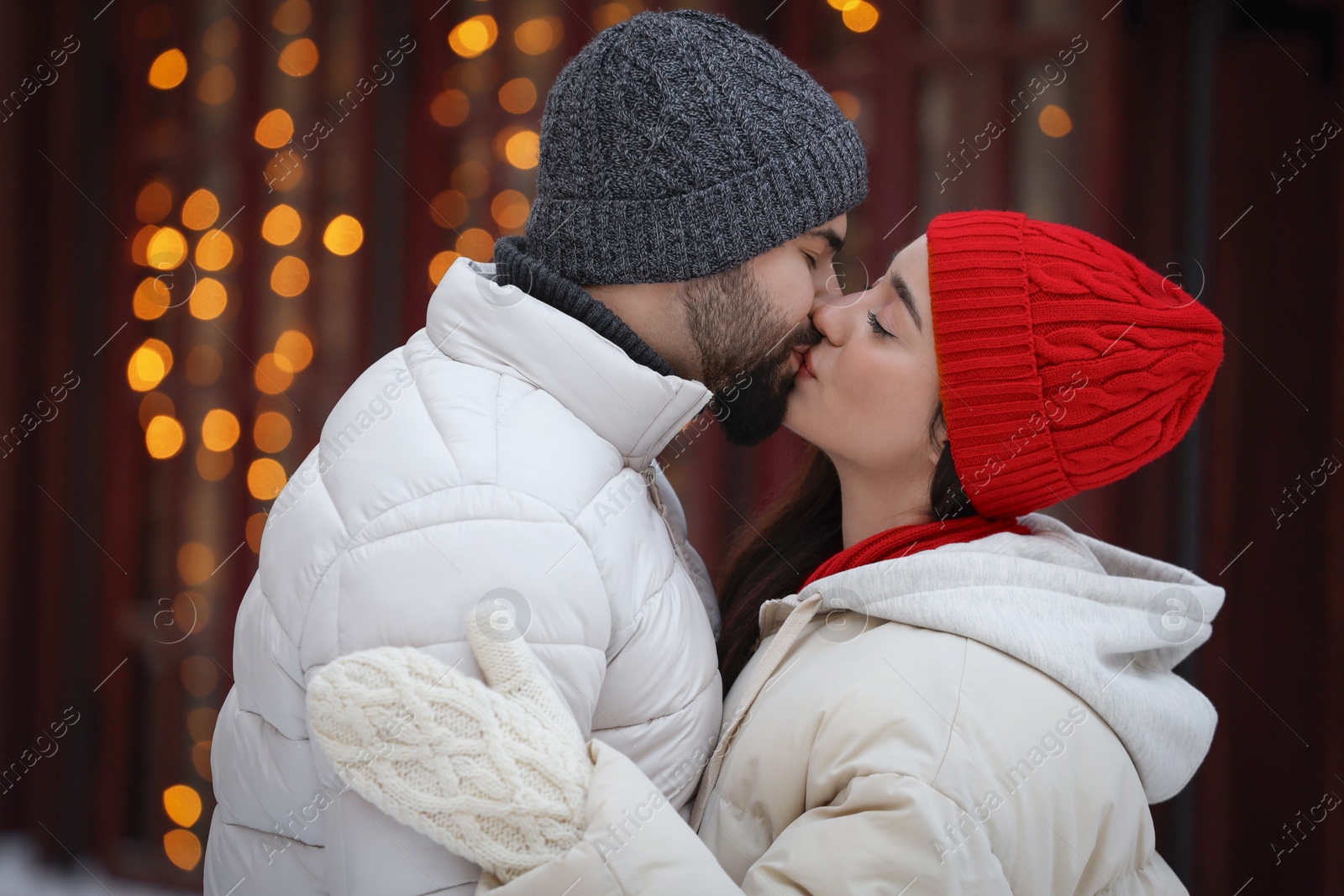 Photo of Portrait of lovely couple outdoors against blurred lights outdoors