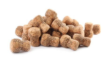 Photo of Heap of sparkling wine corks on white background