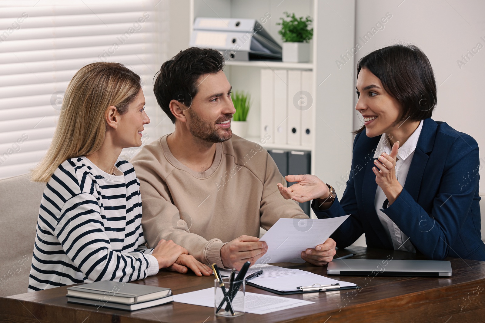 Photo of Professional notary working with couple in office