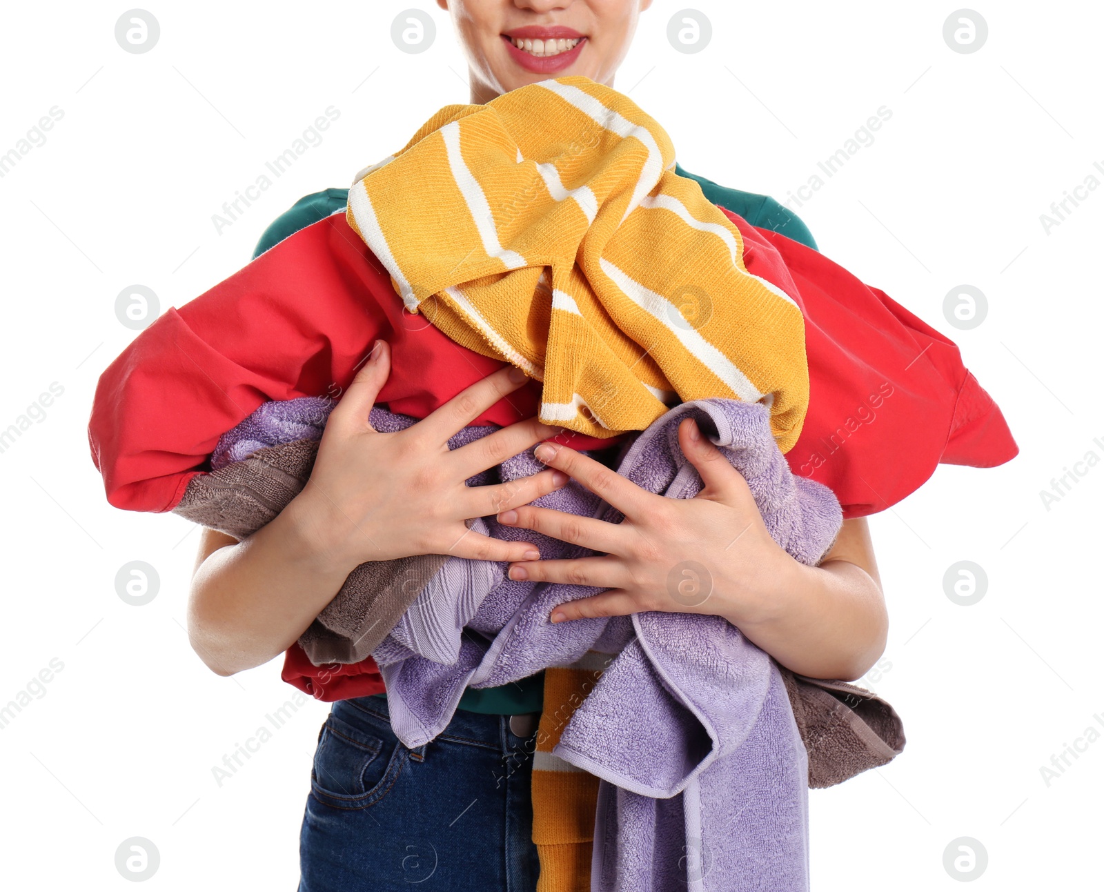 Photo of Young woman holding pile of dirty laundry on white background, closeup