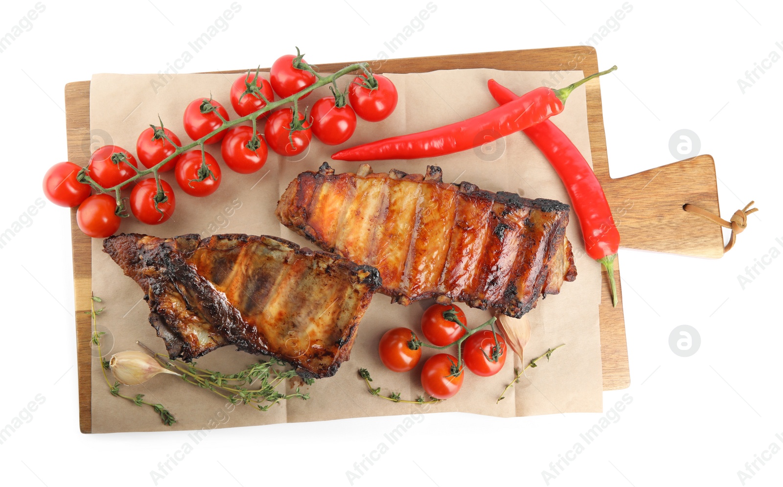 Photo of Tasty grilled ribs with tomatoes and peppers isolated on white, top view