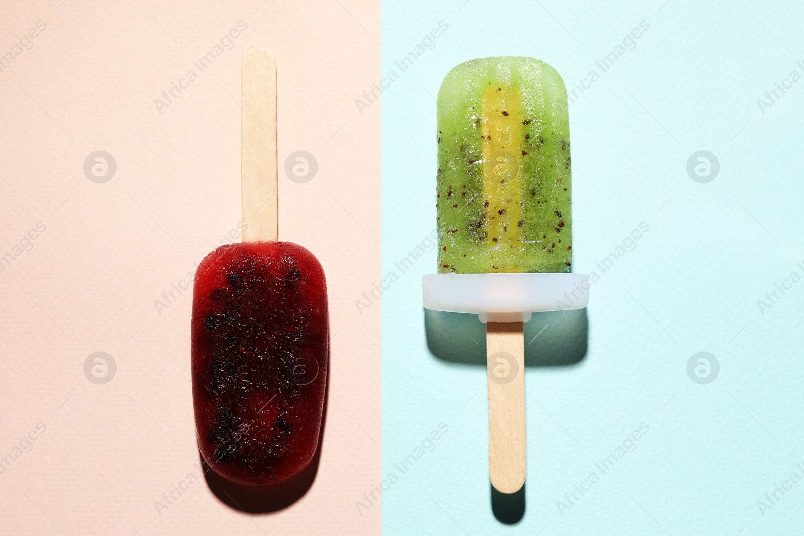 Photo of Tasty blackberry and kiwi ice pops on colorful background, flat lay. Fruit popsicle