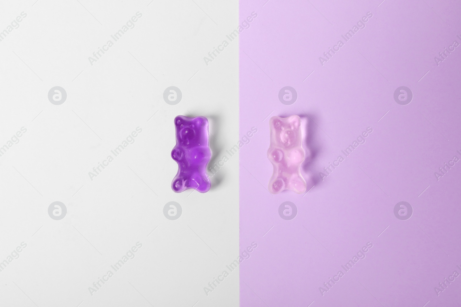 Photo of Delicious jelly bears on color background, top view