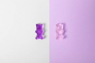 Photo of Delicious jelly bears on color background, top view