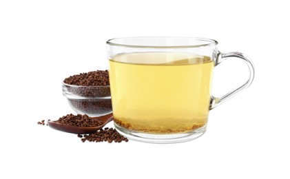 Photo of Cup of aromatic buckwheat tea and granules on white background