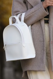 Young woman with stylish white backpack outdoors, closeup