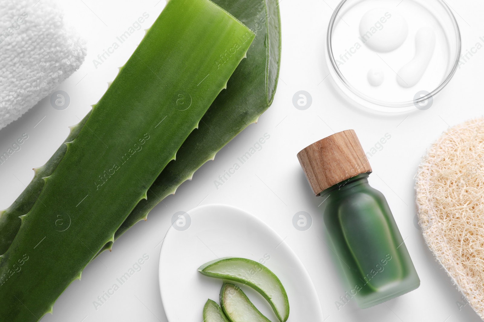 Photo of Flat lay composition with cosmetic products and cut aloe leaves on white background