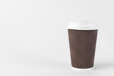 Brown paper cup with plastic lid on light background, space for text. Coffee to go