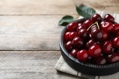 Sweet juicy cherries on wooden table, closeup. Space for text