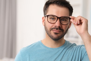 Portrait of man in stylish glasses at home