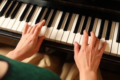 Young woman playing piano, above view. Music lesson