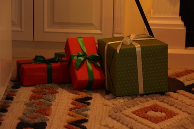 Different Christmas gift boxes on carpet indoors