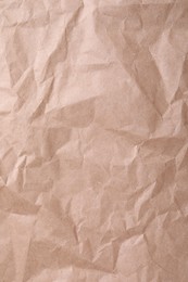 Photo of Texture of wrinkled kraft paper bag as background, closeup