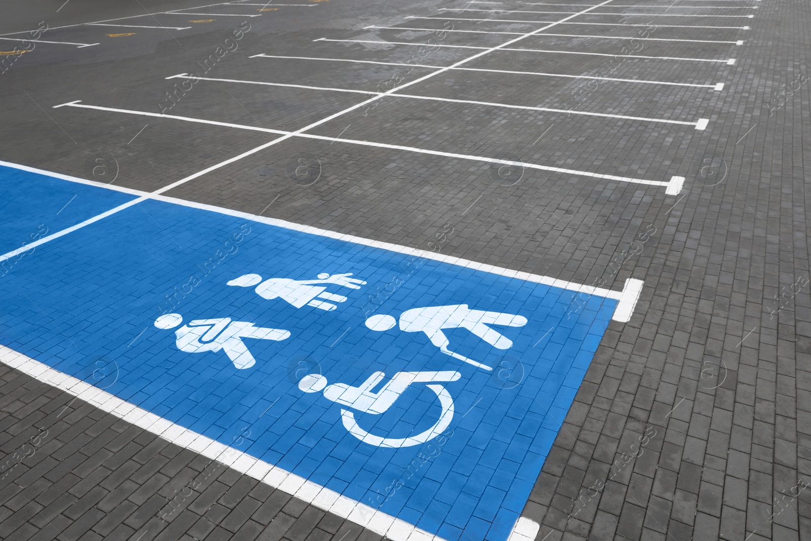 Photo of Empty car parking lot with handicapped symbols outdoors