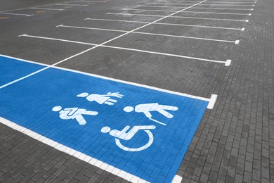 Empty car parking lot with handicapped symbols outdoors