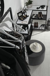 Photo of Rack with stylish women's clothes, shoes and accessories in dressing room, above view