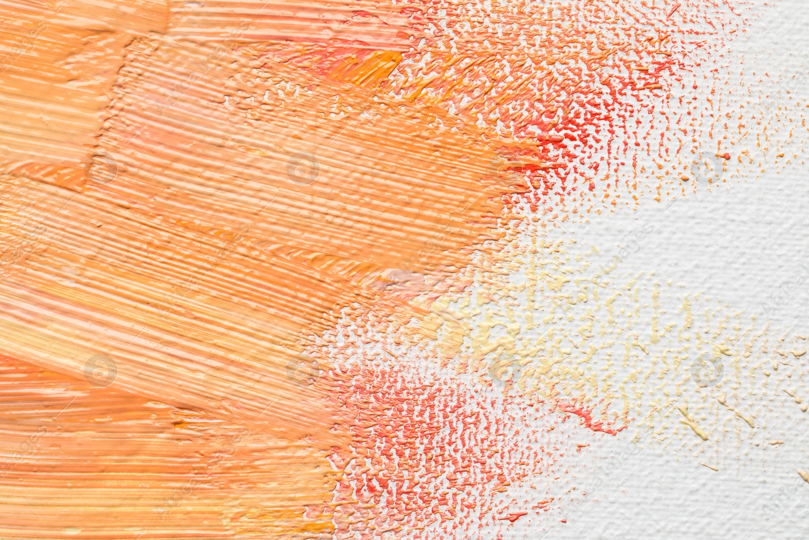 Photo of Beautiful strokes of colorful oil paints on white canvas, closeup