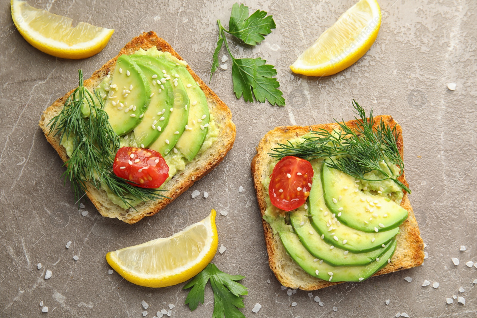 Photo of Tasty crisp toasts with avocado on table, top view