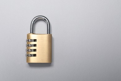 Photo of One steel combination padlock on grey background, top view. Space for text