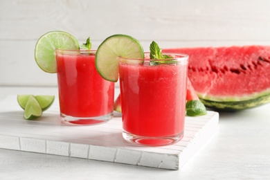 Photo of Tasty summer watermelon drink in glasses served on table